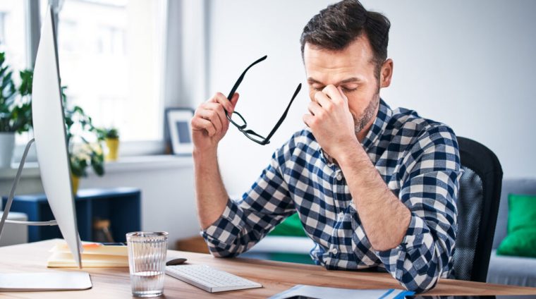 Frustrated, overworked freelancer working from home office