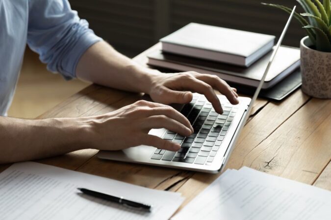 Close,Up,Businessman,Using,Laptop,,Typing,On,Keyboard,,Sitting,At