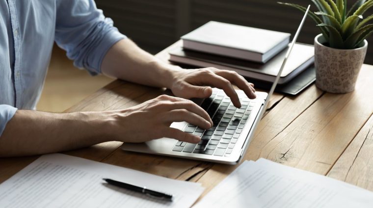 Close,Up,Businessman,Using,Laptop,,Typing,On,Keyboard,,Sitting,At