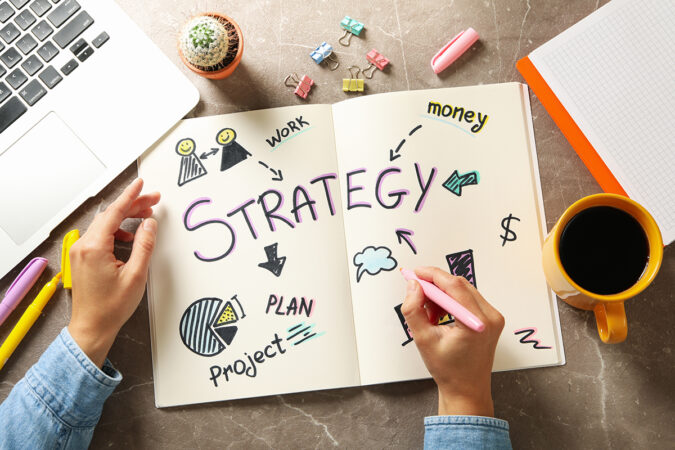 Concept of business strategy on gray table, top view